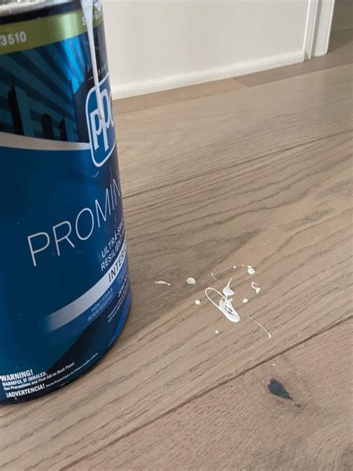Does rubbing alcohol remove paint from wood floors?